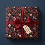 Luxury vintage floral wrapping paper in dark navy and burgundy with a satin ribbon bow by Wrapped Studios.