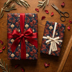 Elegant navy and red floral wrapping paper on gift boxes with ribbons by Wrapped Studios.