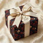 Luxury floral wrapping paper in dark navy and rust with cream ribbon, by Wrapped Studios.