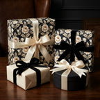 Luxury vintage floral wrapping paper with cream and black velvet bows on gift boxes by Wrapped Studios.