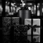 Elegant black and silver gift boxes with ribbon, including floral wrapping paper, ideal for luxury presents.