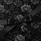 Elegant black floral wrapping paper with a matching satin ribbon and bow.