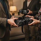 Exchanging gifts wrapped in luxury floral wrapping paper with black satin ribbon.