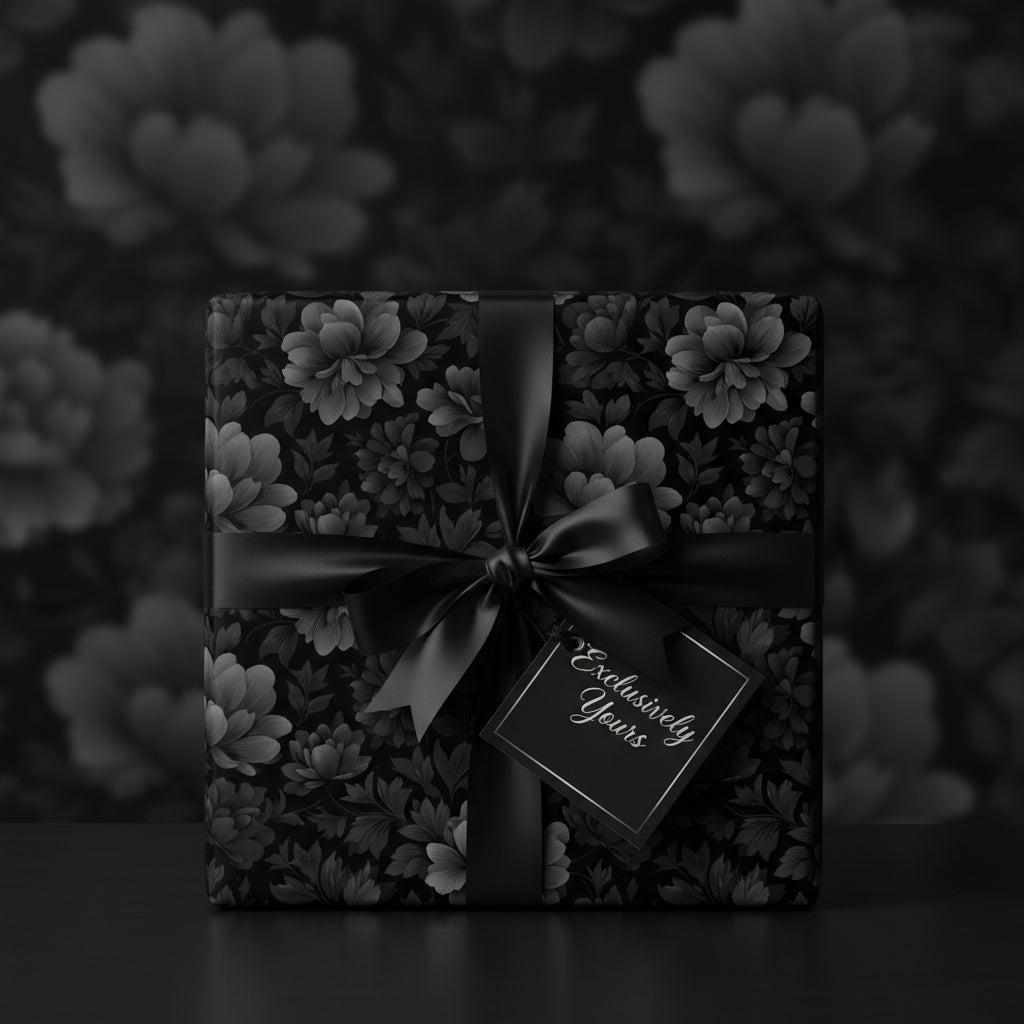 Elegant gift wrapped in black floral wrapping paper with a satin ribbon and "Exclusively Yours" tag.
