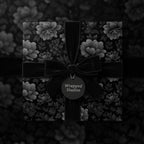 Elegant black floral wrapping paper with velvet ribbon, perfect for luxurious gift presentation.