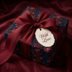 Luxury burgundy floral wrapping paper with a red bow and 'With Love' gift tag, by Wrapped Studios.