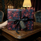 Luxury moody floral wrapping paper with a black ribbon and tag by Wrapped Studios.
