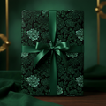 Elegant gift wrapped in dark green floral wrapping paper with matching satin ribbon.