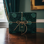 Elegant gift wrapped in green floral wrapping paper with twine bow, perfect for a special occasion.