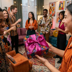 Vibrant floral wrapping paper with a magenta satin bow at a birthday party by Wrapped Studios.