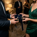 Luxury dark floral gift wrap with a navy velvet ribbon at an elegant holiday party by Wrapped Studios.