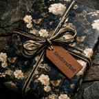 Vintage floral wrapping paper by Wrapped Studios, tied with rustic twine and a handcrafted leather tag.
