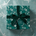 Elegant emerald green floral wrapping paper with a velvet ribbon and gift tag saying "A special moment, just for you."