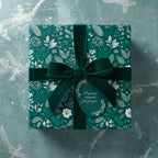 Elegant emerald green floral wrapping paper with a velvet ribbon and gift tag saying "A special moment, just for you."