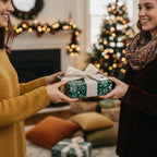 Christmas gift exchange with floral wrapping paper and a cream-colored bow in a festive home.