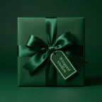 Elegant emerald green gift box with satin ribbon bow for luxury wrapping paper, holiday gift-giving.