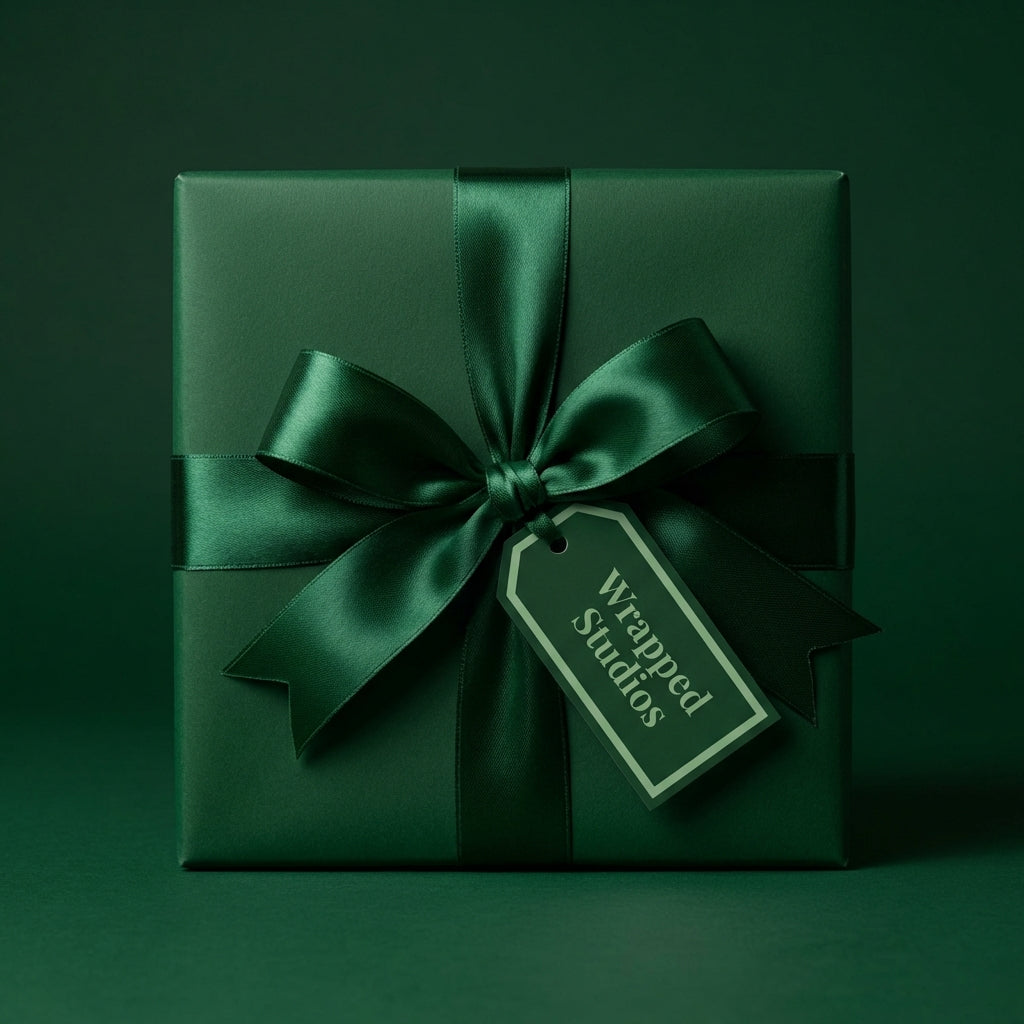 Elegant emerald green gift box with satin ribbon bow for luxury wrapping paper, holiday gift-giving.