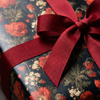 Luxury dark vintage floral wrapping paper with a burgundy ribbon bow, by Wrapped Studios.