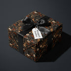 Moody floral wrapping paper with black satin ribbon, luxury botanical gift wrap by Wrapped Studios.
