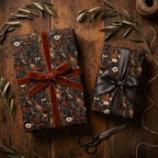 Moody dark floral wrapping paper by Wrapped Studios on gifts with velvet ribbons on a rustic wood table.