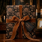 Luxury black and bronze floral wrapping paper with a velvet bow by Wrapped Studios.