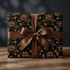 Luxury dark floral wrapping paper with a brown ribbon on a gift box by Wrapped Studios.