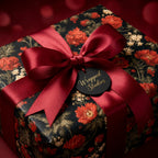 Luxury floral wrapping paper with a red satin bow and Wrapped Studios tag, perfect for Christmas.
