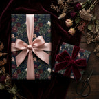 Luxury dark floral wrapping paper with pink satin and burgundy velvet bows by Wrapped Studios.