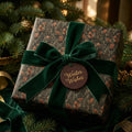 Forest Christmas wrapping paper with velvet green bow and winter wishes tag by Wrapped Studios.