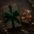 Luxury woodland Christmas wrapping paper with green velvet bow on rustic wood by Wrapped Studios.