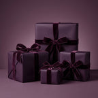 Elegant plum wrapping paper with velvet ribbon bows on stacked gift boxes.