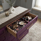 Dark floral wrapping paper used as a luxury drawer liner in a purple dresser by Wrapped Studios.