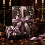 Moody vintage floral wrapping paper with lilac satin bows on luxury gift boxes, by Wrapped Studios.