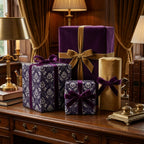 Luxury purple and gold damask gift wrap with velvet bows on a wooden desk by Wrapped Studios.