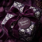 Luxury dark purple floral wrapping paper with a velvet ribbon bow on a gift box, by Wrapped Studios.