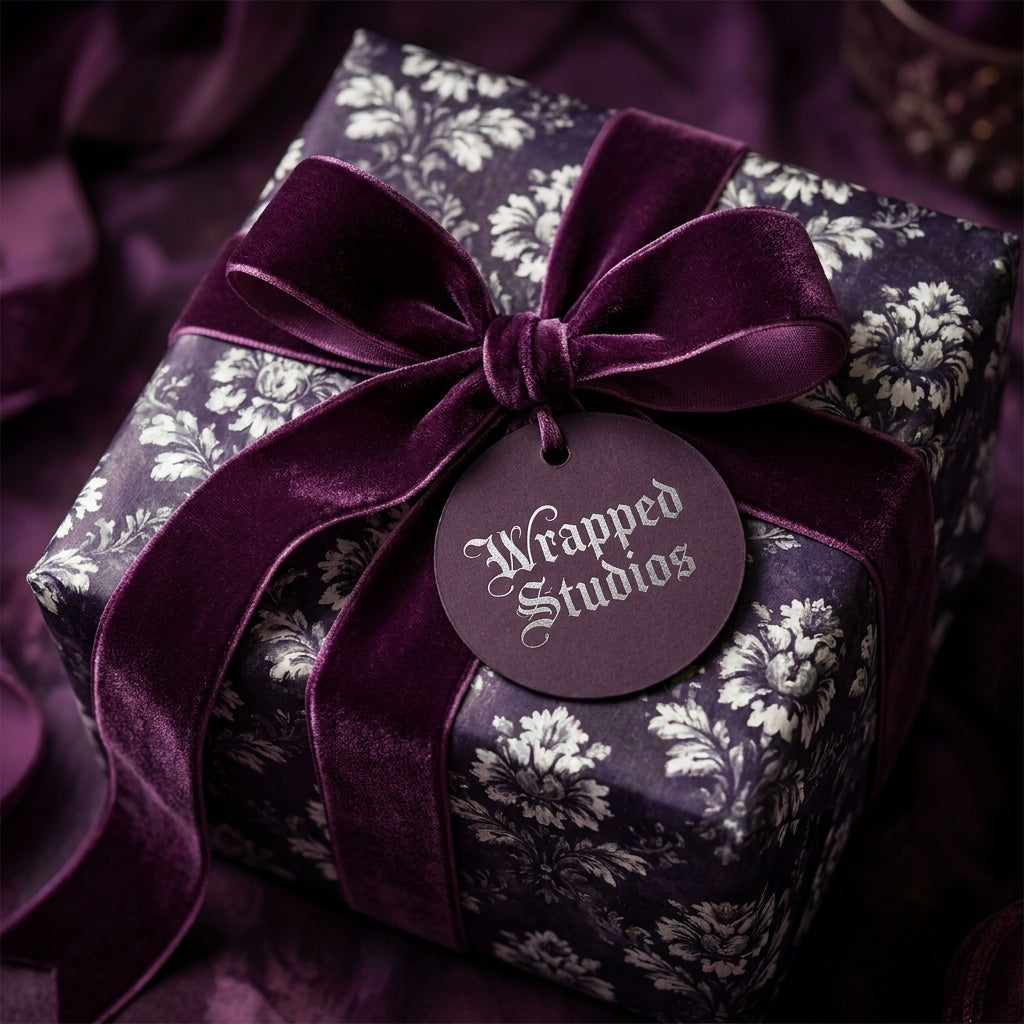 Luxury dark purple floral wrapping paper with a velvet ribbon bow on a gift box, by Wrapped Studios.