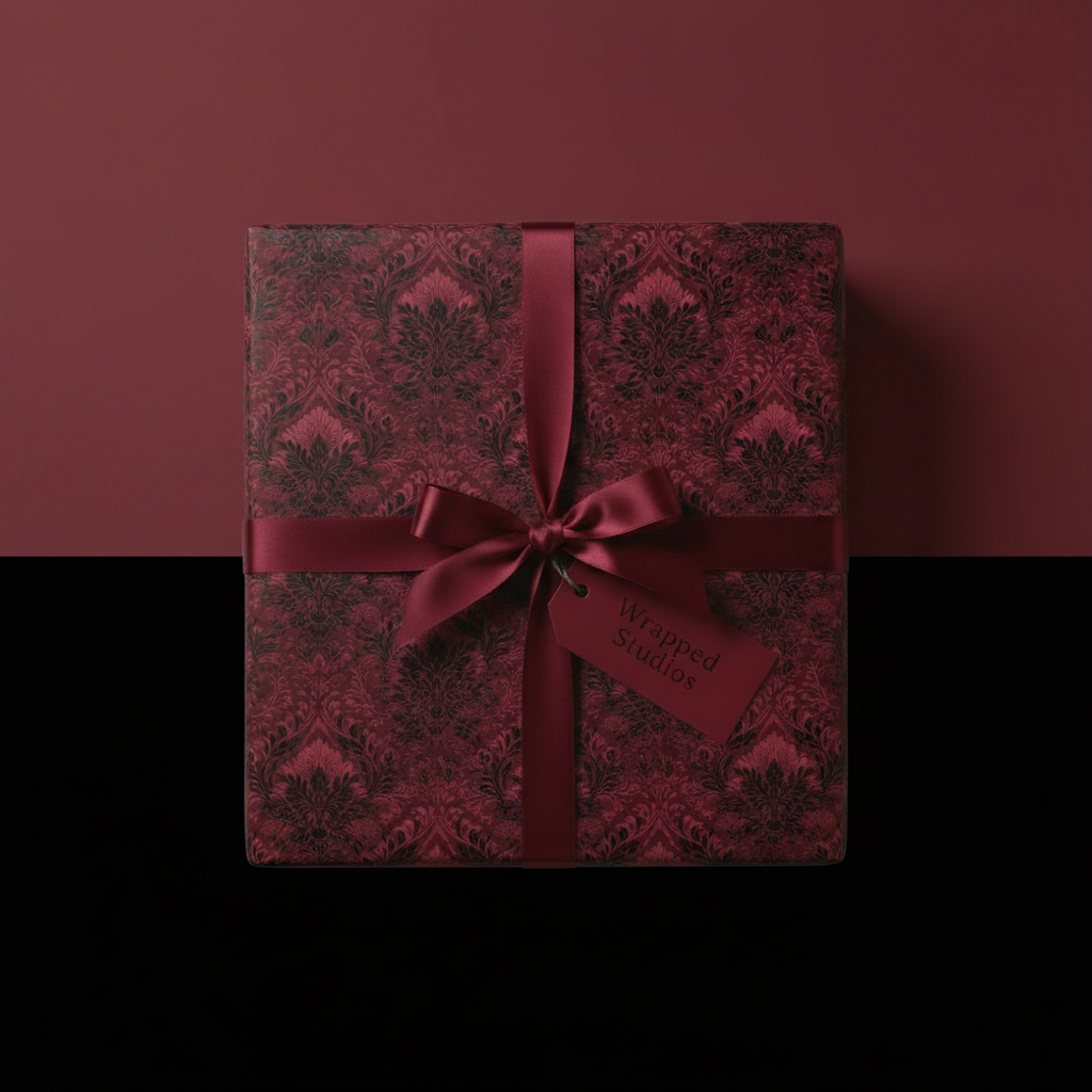 Elegant gift with luxury wrapping paper, damask floral pattern, burgundy ribbon.