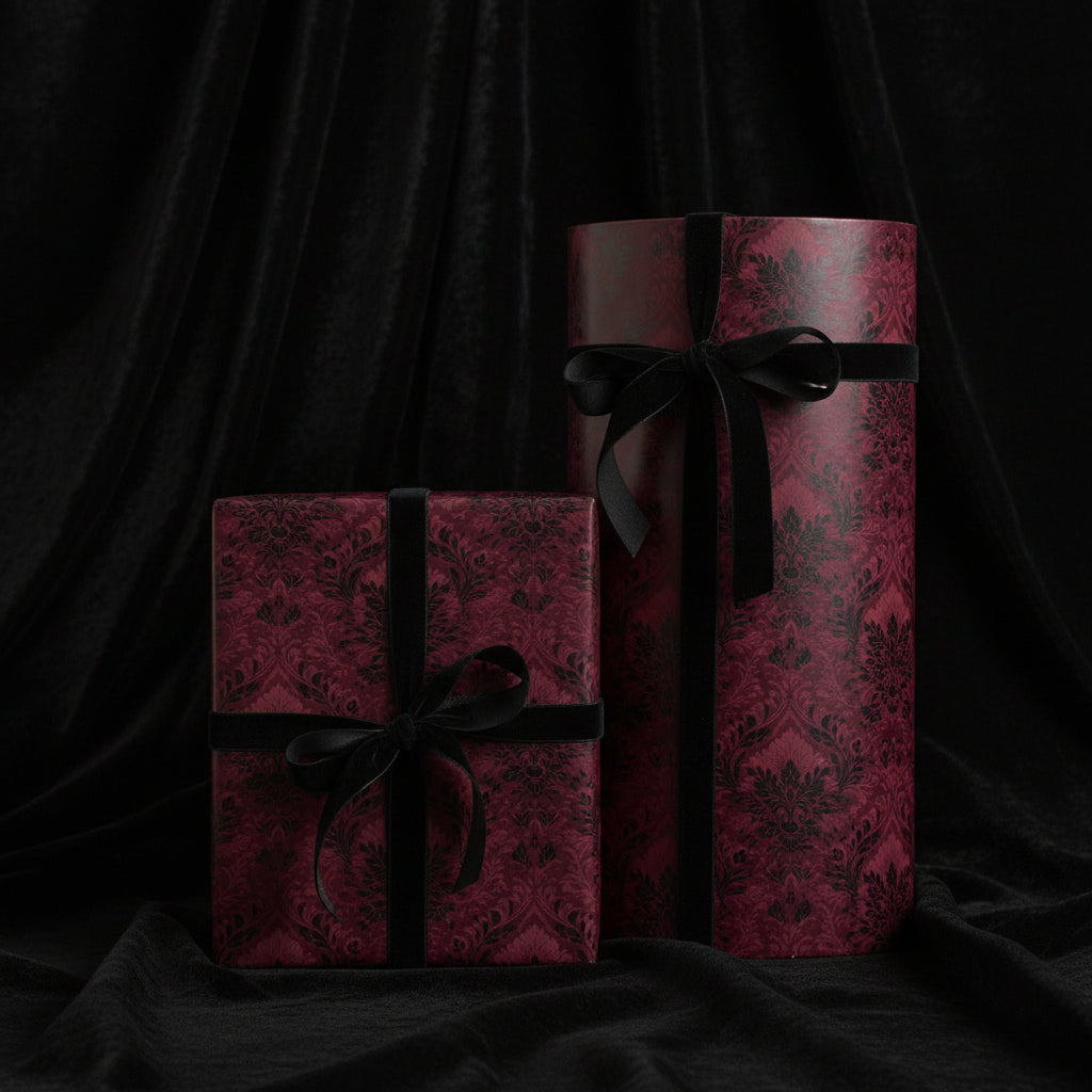 Elegant maroon and black damask wrapping paper with velvet ribbon on square and round gift boxes.