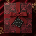 Burgundy gift box wrapped in elegant floral wrapping paper with "With Love" tag and matching ribbon.