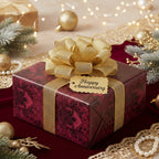 Elegant floral anniversary gift wrapped in burgundy paper with a gold ribbon and bow.