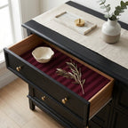Burgundy striped wrapping paper used as luxury drawer liner in a black dresser, by Wrapped Studios.