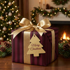 Burgundy striped Christmas wrapping paper with a luxury gold bow by Wrapped Studios.