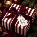 Luxury red and white striped Christmas wrapping paper with a velvet bow, by Wrapped Studios.