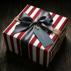 Red and white striped Christmas wrapping paper with grey satin bow and holiday gift tag by Wrapped Studios.