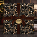 Elegant Christmas gift wrapped in floral black and gold paper with a velvet brown ribbon.