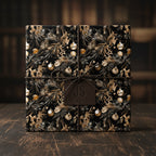 Elegant Christmas gift wrapped in black and gold holiday wrapping paper with twine and leather tag.