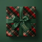 Elegant red and green plaid Christmas wrapping paper with a luxury satin bow by Wrapped Studios.