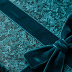 Teal luxury wrapping paper with a matching velvet ribbon and geometric pattern by Wrapped Studios.