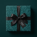 Luxury teal textured wrapping paper with a black satin bow on a gift box, by Wrapped Studios.