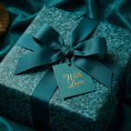 Luxury teal wrapping paper with elegant ribbon and "With Love" gift tag by Wrapped Studios.